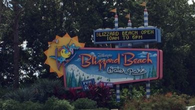 Blizzard Beach entrance sign with park hours