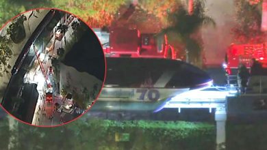 Disneyland Monorail halted at night as emergency crews respond to a power outage, with guests visible in an aerial inset.