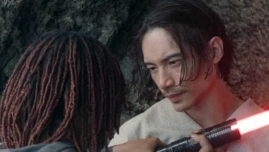 Osha Aniseya (Amandla Stenberg) holding a red lightsaber up to Qimir/The Stranger (Manny Jacinto) in 'The Acolyte'