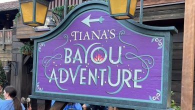 A directional sign for Tiana's Bayou Adventure at Magic Kingdom Park.