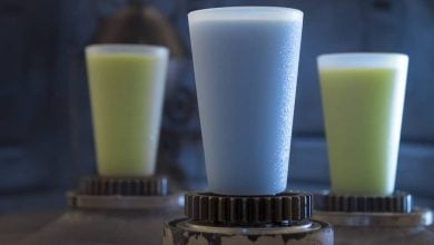 Three frosty cups of blue and green milk.