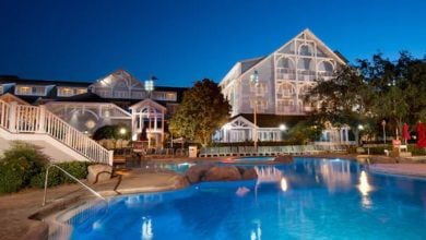 Exterior of Disney's Beach Club and the pool lit up at night