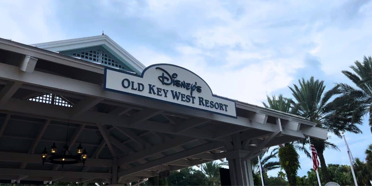 Disney’s Old Key West Resort welcome sign surrounded by lush palms, setting the scene for a magical Disney World escape.