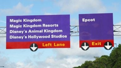 Iconic purple Disney World signs point fans to Magic Kingdom, resorts, Animal Kingdom, Hollywood Studios, and Epcot.