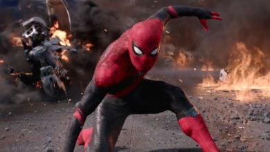 Tom Holland as Spider-Man sticks the landing with burning motorcycle in background. From Marvel's 'Spider-Man: Far From Home' film