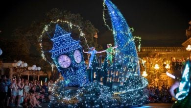 The Peter Pan float dazzles Magic Kingdom fans at night, with Big Ben towering and beloved Disney characters joining the parade.