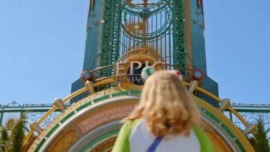 guest in front of entrance to Universal's Epic Universe theme park