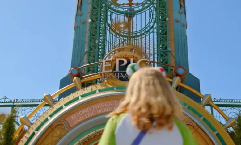 Guest in front of entrance to Universal's Epic Universe theme park. Epic Universe ticket prices