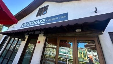 Crazyshake by Black Tap at Universal CityWalk, with vibrant windows and iconic black awning sparkling under the sun.