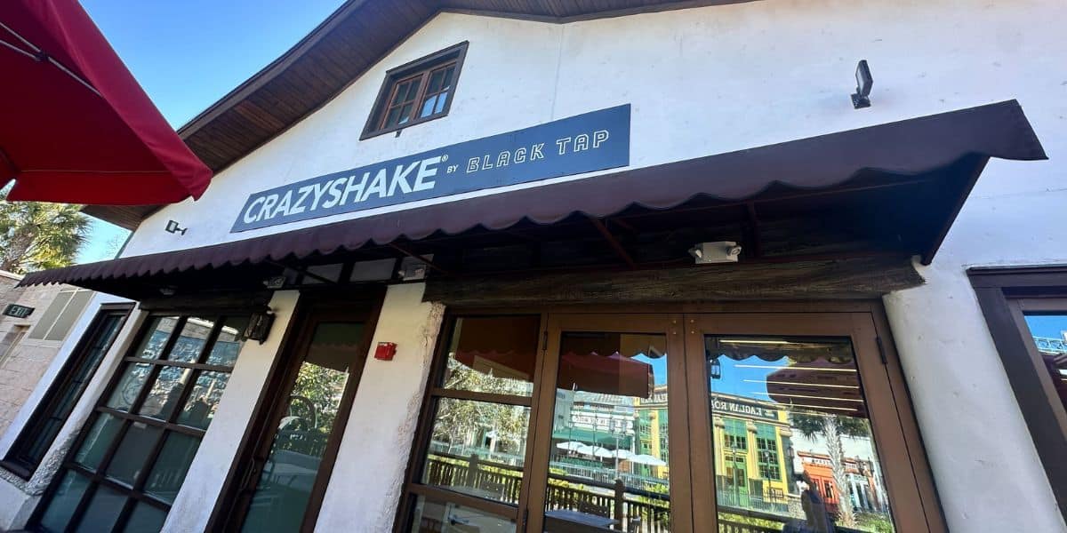 Crazyshake by Black Tap at Universal CityWalk, with vibrant windows and iconic black awning sparkling under the sun.