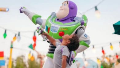 a young guest poses with Buzz Lightyear in Toy Story Land in Disney's Hollywood Studios park. Walt Disney World ride reopenings 2026.