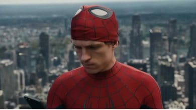 Spider-Man (Tom Holland) unmasked with NYC in the background