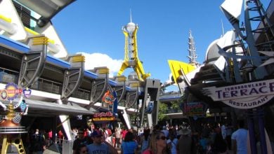 Guests walking through Tomorrowland at Magic Kingdom Park
