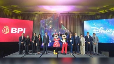 Minnie and Mickey join executives in formalwear on stage, framed by BPI and Disney logos, marking an exciting partnership celebration.