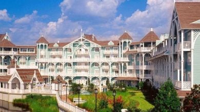 Disney's Beach Club Resort, known for its pastel blue and white Victorian style, now sports mustard yellow paint in progress.
