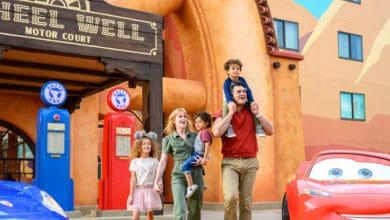 A family in front of Cars section of Disney's Art of Animation Resort hotel