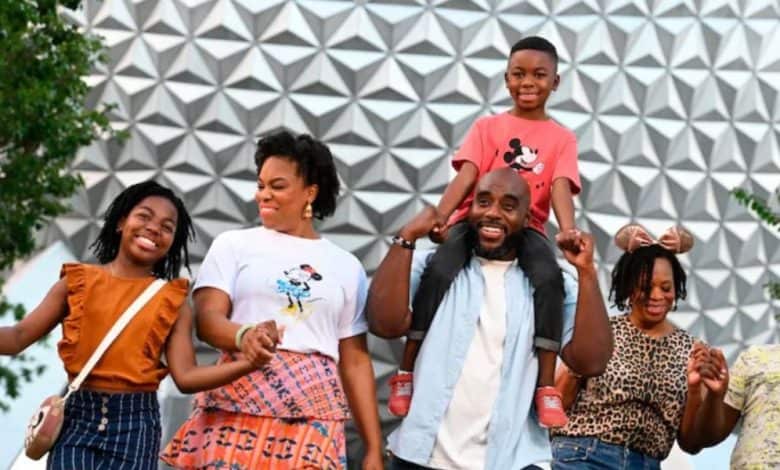 family in front of spaceship earth in disney world's epcot park