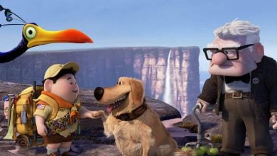 Russell, Dug, Carl, and Kevin from Disney Pixar's Up pose together near rocky cliffs
