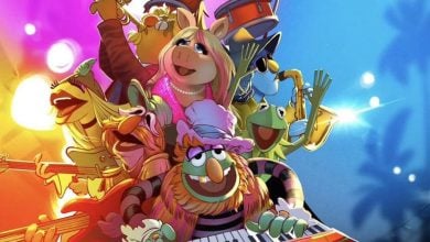 The Muppets band rocks out onstage amid vibrant lights and a blue-pink backdrop as Rock 'n' Roller Coaster walls come down.