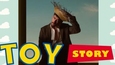 Woody from Toy Story poses in front of the iconic film logo and cloud backdrop, creating a magical Pixar experience.