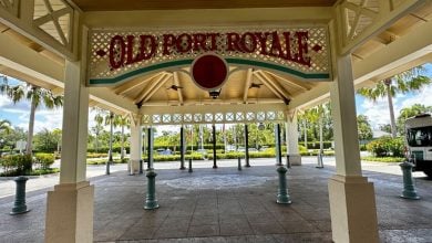Old Port Royale’s covered entrance welcomes guests with palm trees and a white van—your gateway to Disney World’s top breakfasts.