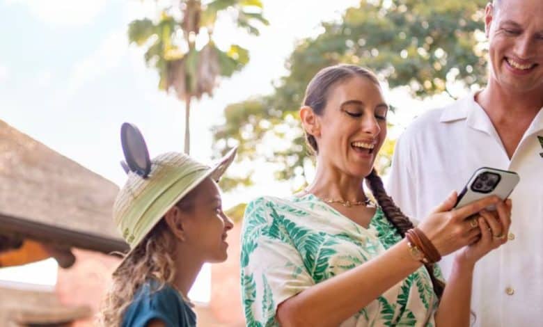 family uses phone at Disney World