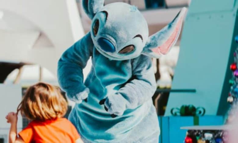 Disney's stitch mascot interacts with a young guest at disney world