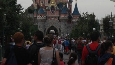 Guests heading toward Sleeping Beauty Castle at Disneyland Paris.