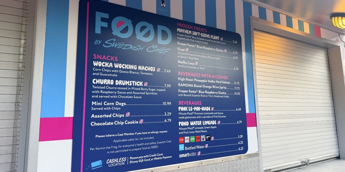 Themed Swedish Chef menu at a vibrant blue concession stand, listing snacks, frozen treats, and drinks with theme park prices.