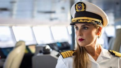 Captain Maria stands proudly on the ship’s bridge, dressed in her official captain’s uniform and ready to greet guests on their nautical adventure.
