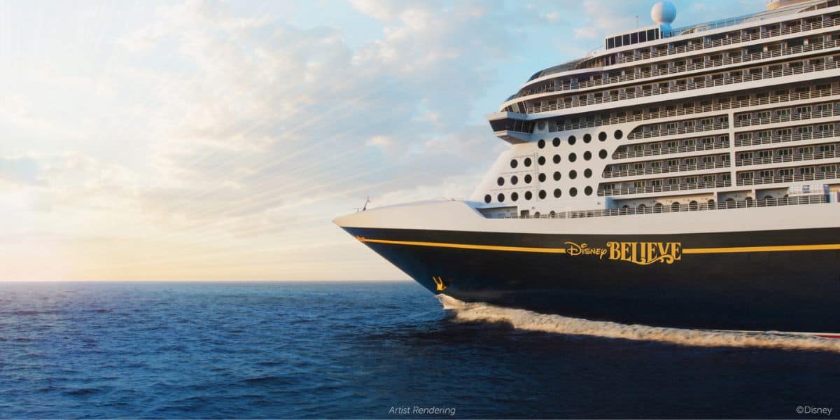 Disney Believe, helmed by the famous Captain Maria, glides across the ocean at sunset under partly cloudy skies, inviting guests to experience the magic and adventure of a Disney cruise.