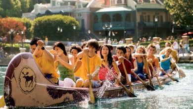 Guests paddle a canoe on the Rivers of America at Disneyland
