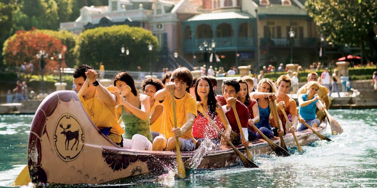 Guests paddle a canoe on the Rivers of America at Disneyland