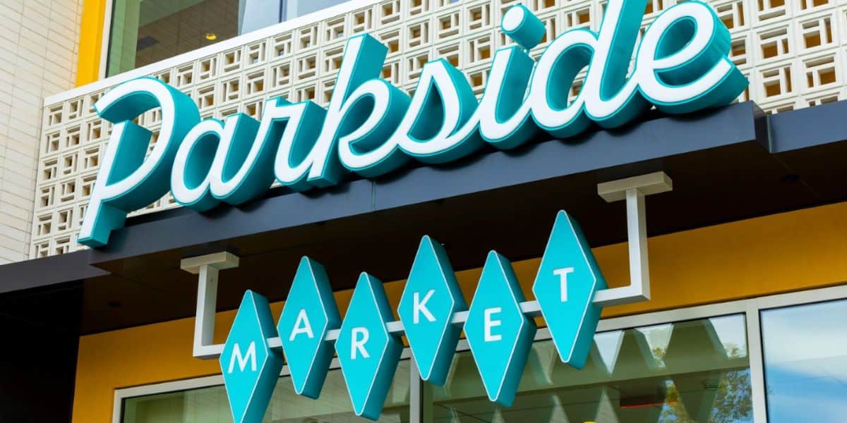Parkside Market's bold teal sign welcomes Disney fans, with geometric accents and exclusive VIP perks in Downtown Disney.