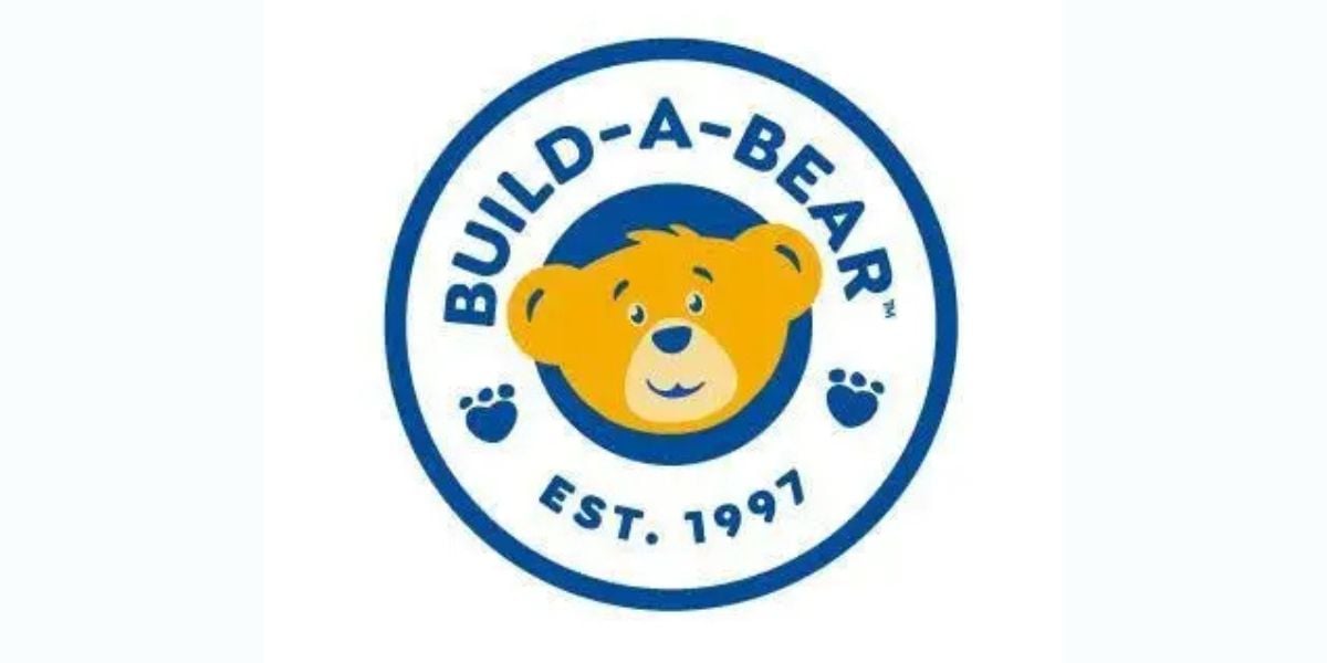 Build-A-Bear logo featuring the signature bear face in a fun blue and yellow circle, with "Est. 1997" welcoming guests.