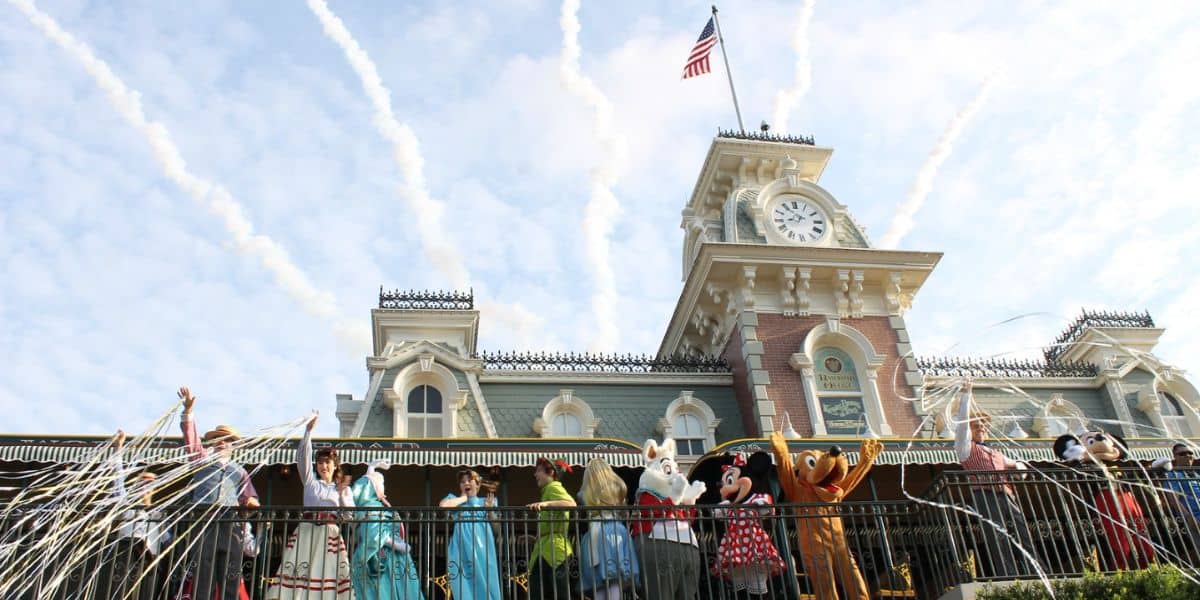 Mickey Mouse and friends wave to fans from the balcony of the Main Street USA train station at Magic Kingdom