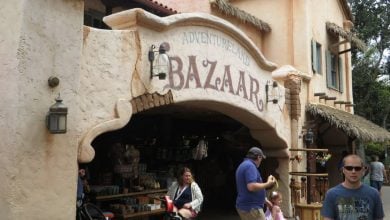 Guests stroll by the Adventureland Bazaar at Disneyland Park