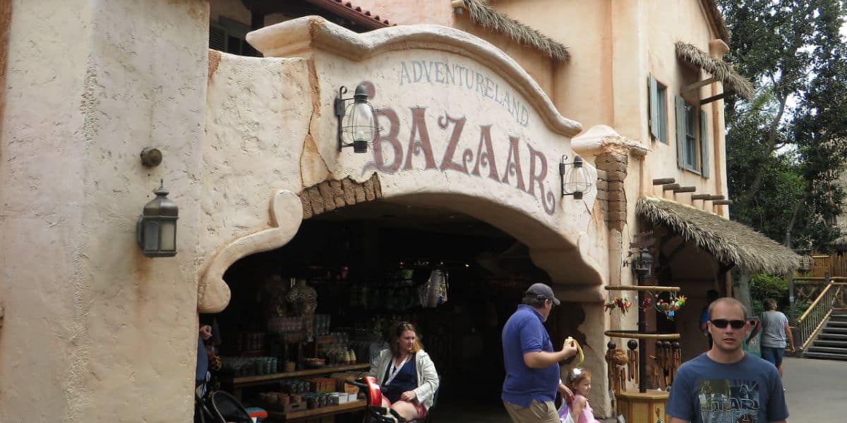 Guests stroll by the Adventureland Bazaar at Disneyland Park