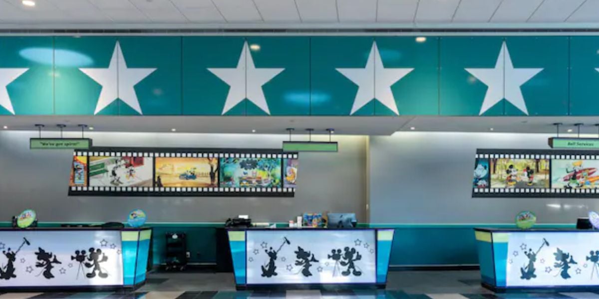 Step into the lively Disney World Resort lobby decorated with teal star accents and filmstrip-themed artwork, where counters showcase beloved cartoon character silhouettes. Please note, some sections might be temporarily closed or altered due to ongoing construction, impacting certain guest experiences.