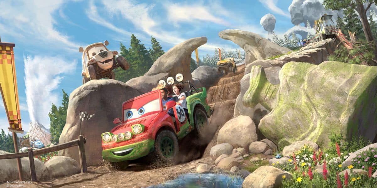 Colorful animated cars speed along a rugged dirt track, packed with excited guests, surrounded by lush greenery and under a bright sky—capturing the thrill of a theme park racing ride.