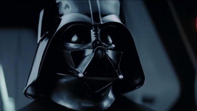 Darth Vader, in his iconic black helmet and mask, looms in a shadowy corridor reminiscent of his legendary appearances, inviting Star Wars fans to experience the epic presence made famous by Hayden Christensen.