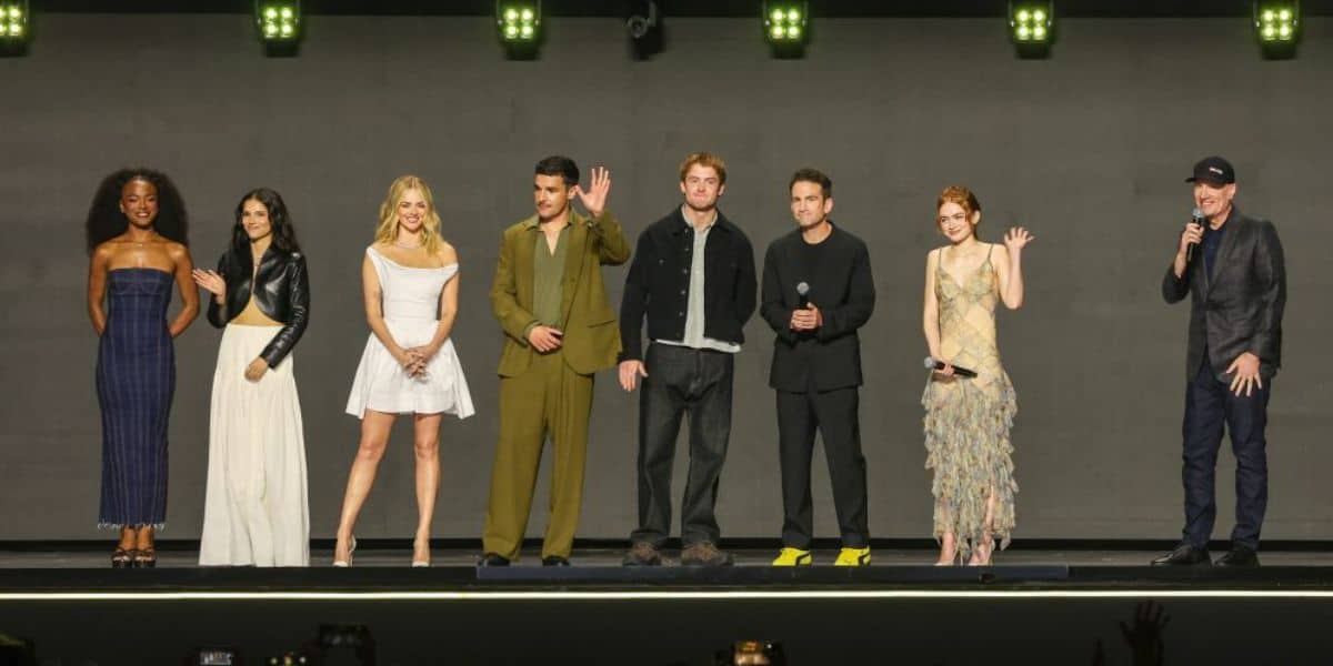 Onstage at the D23 2026 Entertainment Showcase, eight presenters stand under dazzling lights, some holding microphones to share big announcements while others wave and grin directly at us, bringing the excitement and energy of Disney’s signature celebration right to the audience.