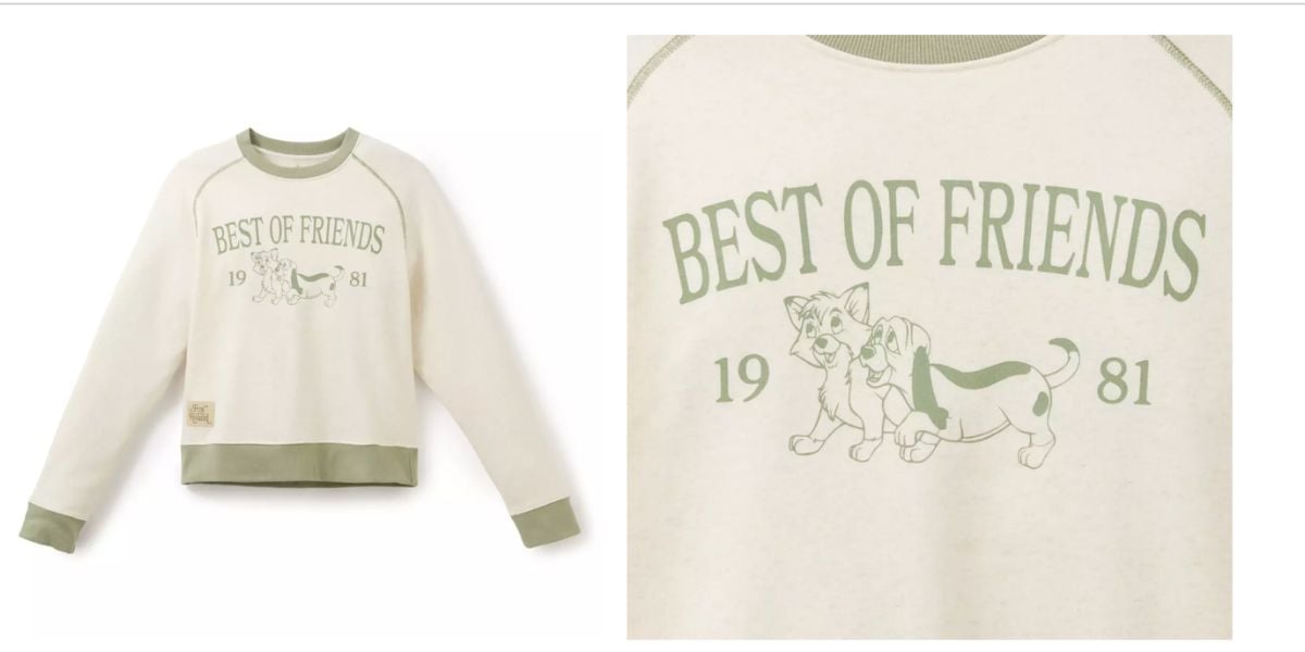 Cream sweatshirt with green trim, featuring Disney’s “Best of Friends 1981” and iconic canine pals from The Fox and the Hound printed on the front—a collectible piece perfect for Disney Parks guests and fans of classic animated movies.