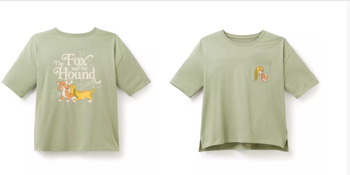 Light green T-shirt featuring “The Fox and the Hound” Disney artwork on the front, with a character name detail on the pocket; perfect for Disney Parks fans and collectors looking to celebrate this beloved classic.
