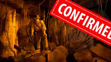 Indiana Jones stands among ancient ruins, his iconic fedora in place, with a bold red “CONFIRMED” stamp across the image—signaling exciting new effects soon debuting on Indiana Jones Adventure at Disneyland.