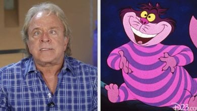 A guest in a blue plaid shirt poses with the whimsical Cheshire Cat from Disney’s “Alice in Wonderland,” the iconic character brought to life by Disney Legend Jim Cummings.