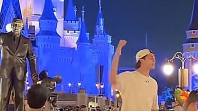 A screenshot from a TikTok of a man preaching at Magic Kingdom
