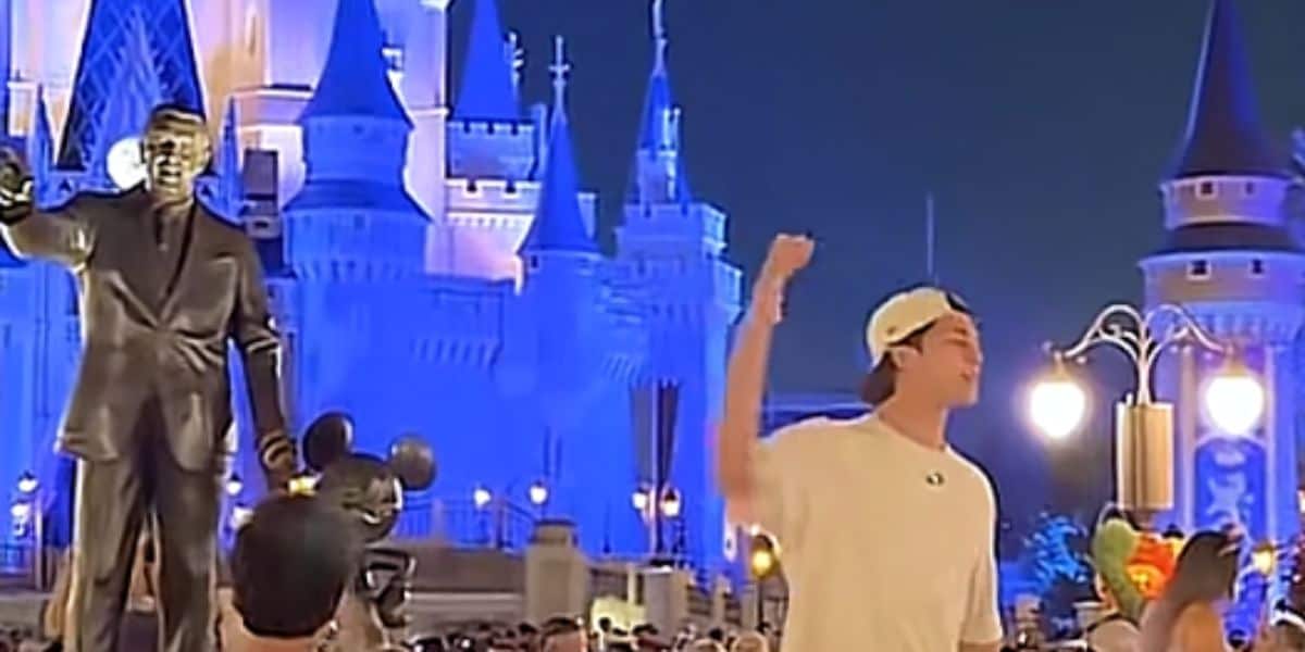 A screenshot from a TikTok of a man preaching at Magic Kingdom
