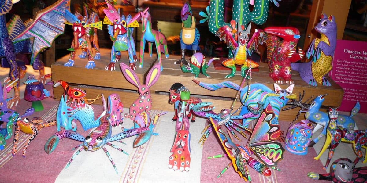 Vividly painted Oaxacan wood animal figurines sit clustered on a table in the Mexico Pavilion at EPCOT