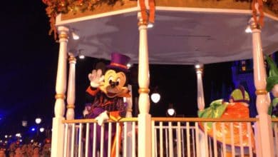 Mickey Mouse waves to fans from his Halloween parade float at Disney World.